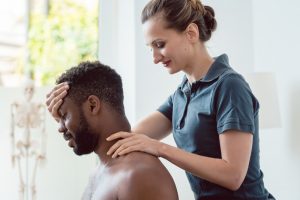 Chiropractor working on man's neck